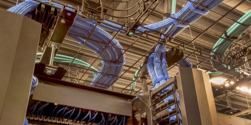 Cable trays in a data center with cat 5 and optic fiber cables.