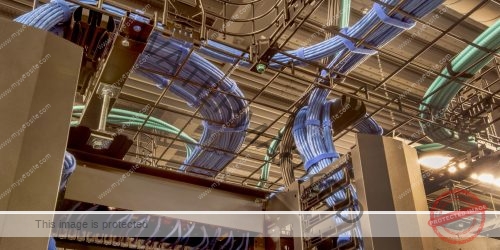 Cable trays in a data center with cat 5 and optic fiber cables.